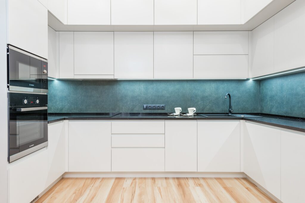 white cabinets with black kitchen appliances