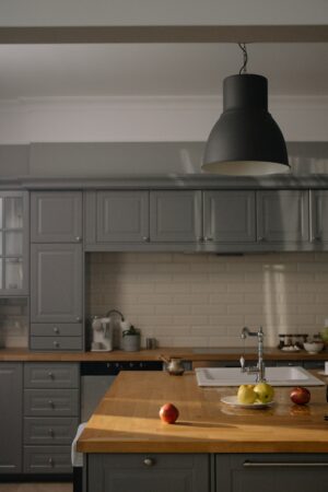 grey kitchen cabinets with wooden countertop