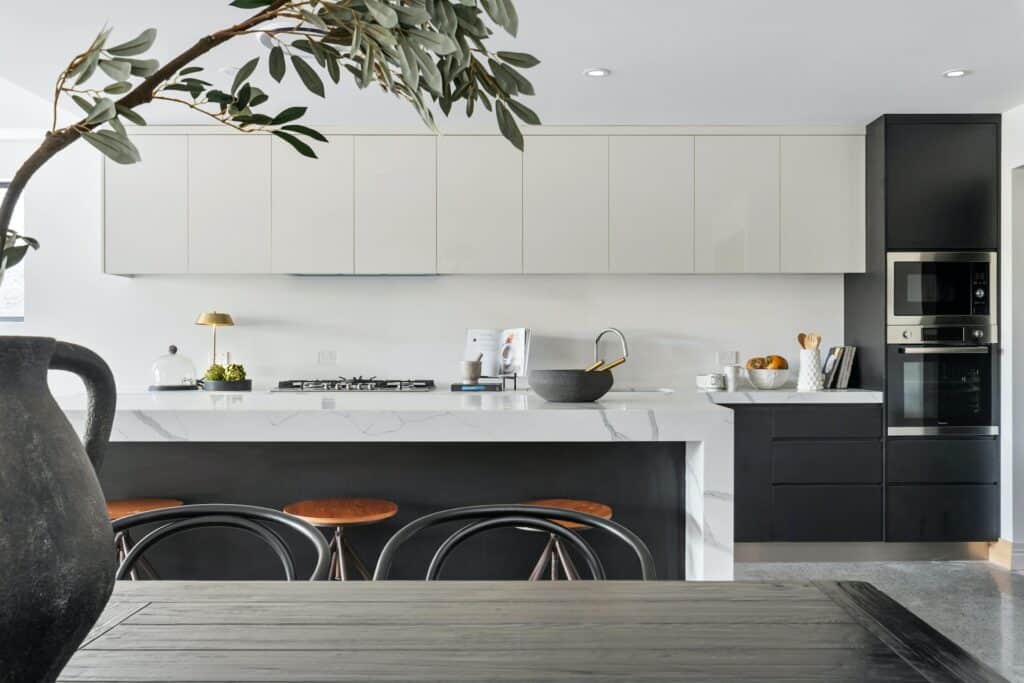 black kitchen cabinets and white worktops