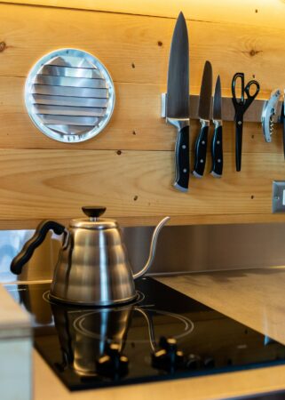 black kitchen stovetop having a white kettle