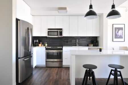 grey steel 3-door refrigerator near a modular kitchen
