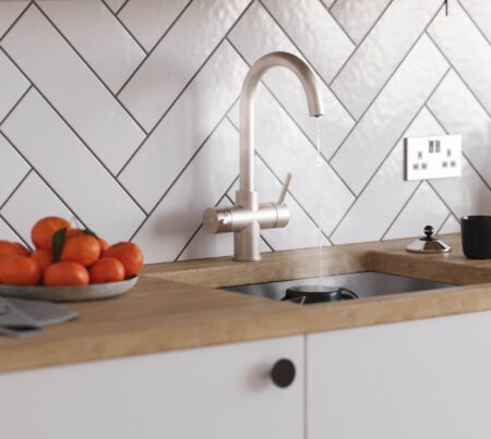 a brushed nickel tap inside a modern kitchen