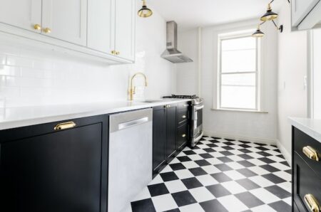 black and white kitchen cabinets with a patterned black and white floor tile