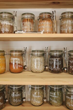 Variety of Spices in Glass Jars on Wooden Shelves