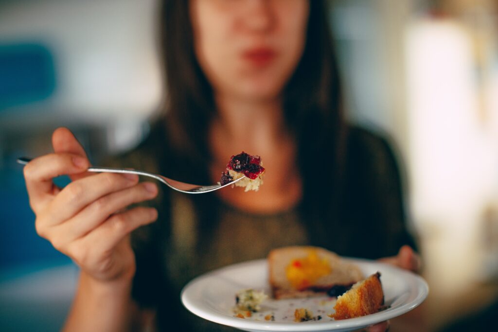 woman holding plate with a cake on