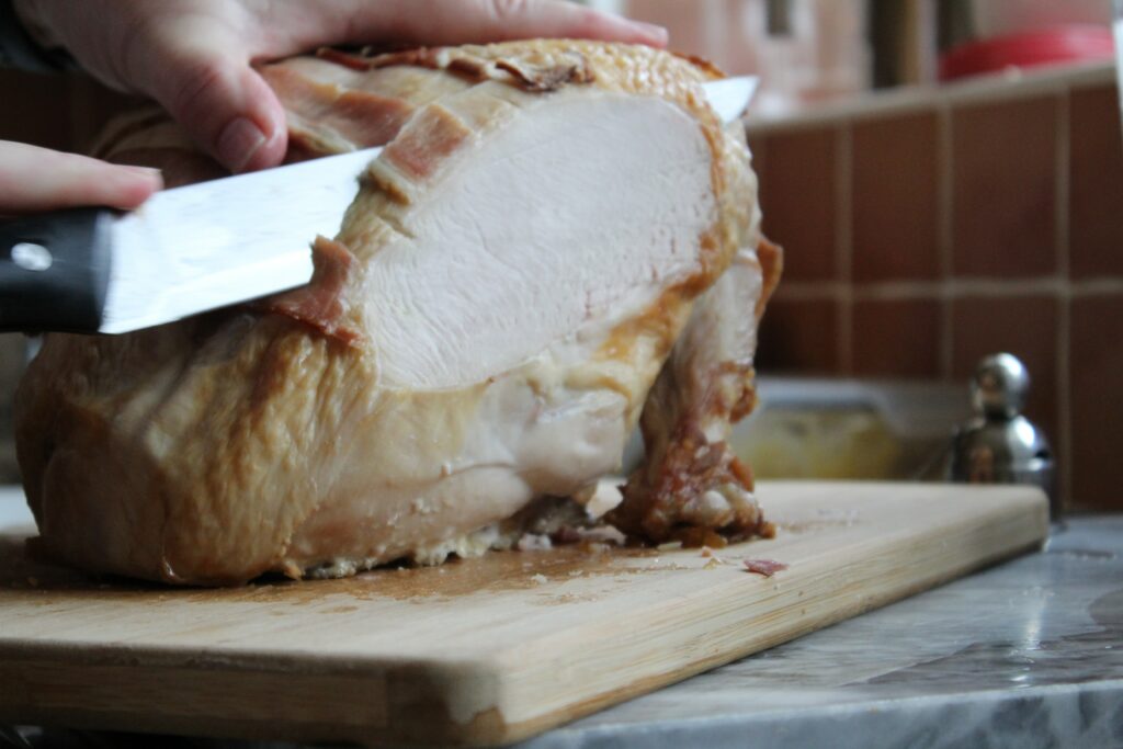 cutting meat on chopping board