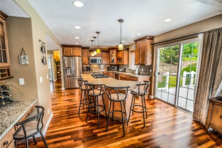 a kitchen island beside barstools