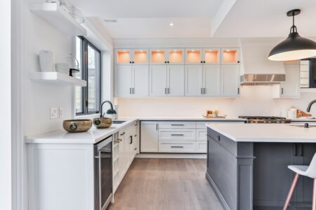 an interior view of a white wooden kitchen cabinet