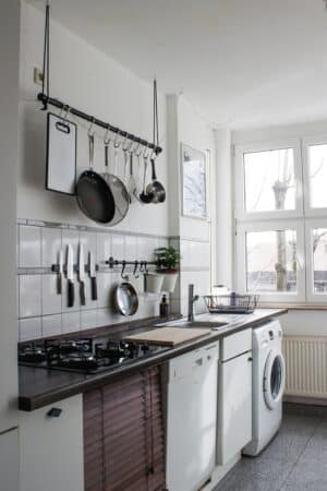 a white dishwasher beside a kitchen window