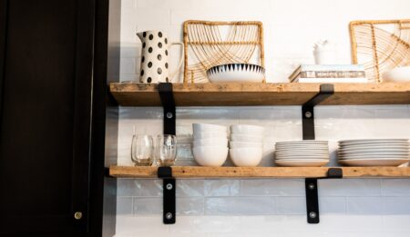 Dishware and glasses on shelves in cafe kitchen