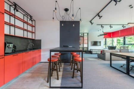 a red and grey kitchen interior with modern furniture