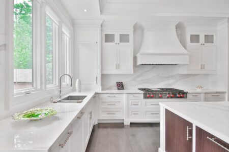 a white wooden kitchen cabinet beside a sink