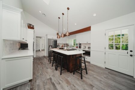 a modern kitchen interior with copper pendant light