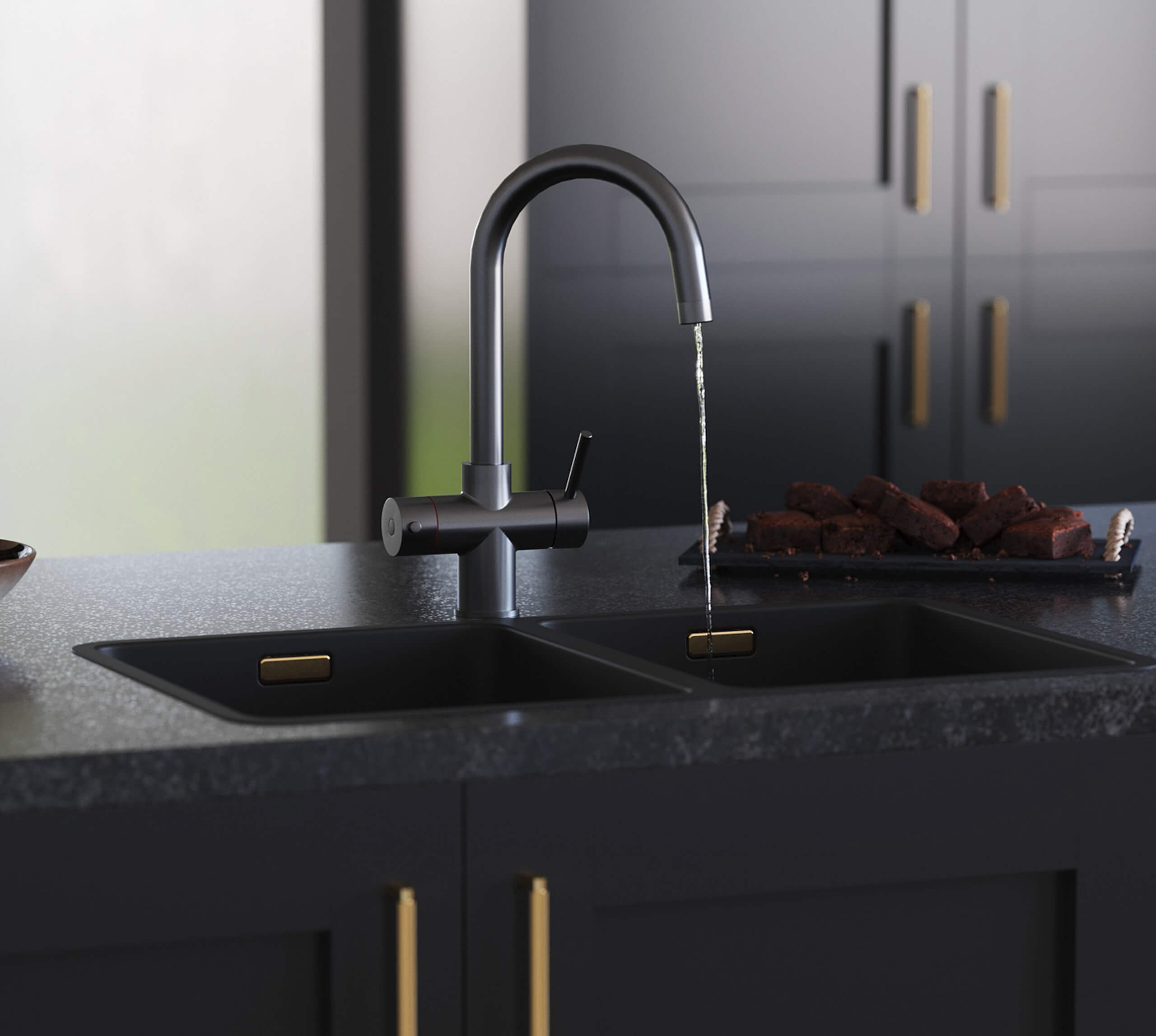 a swan neck gunmetal hot water tap on a black kitchen countertop dispensing water