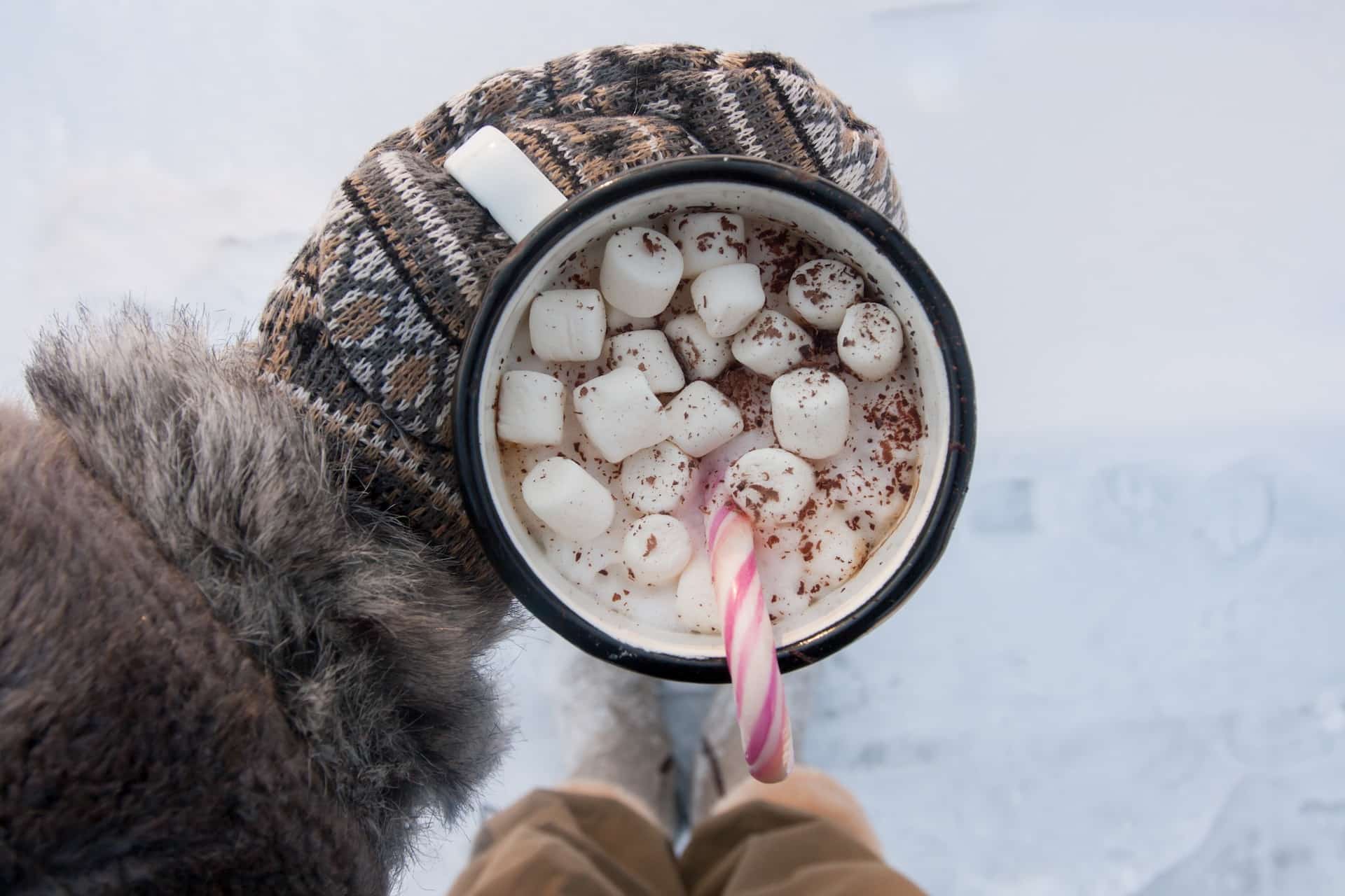 hot chocolate with marshmallows outside in the snow