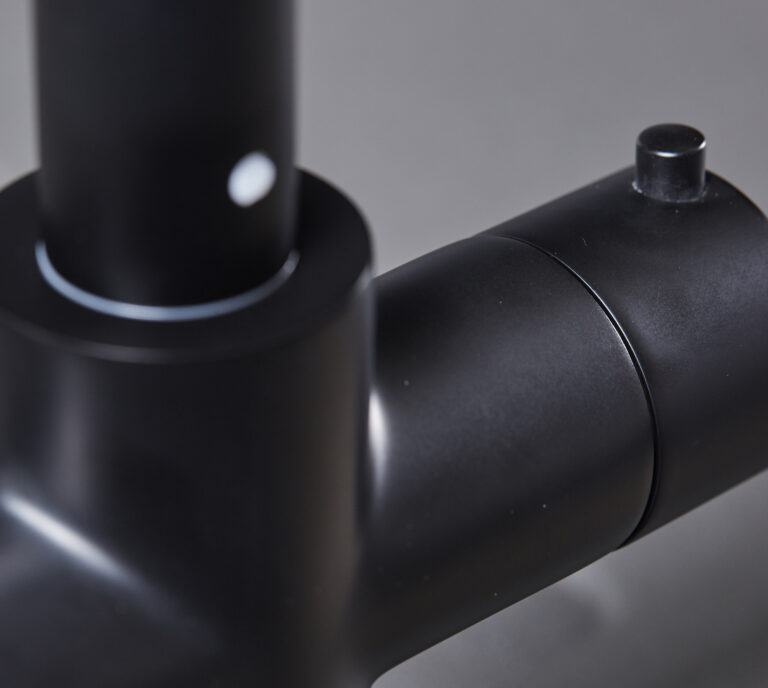 Close-up of a matte black hot water tap right handle