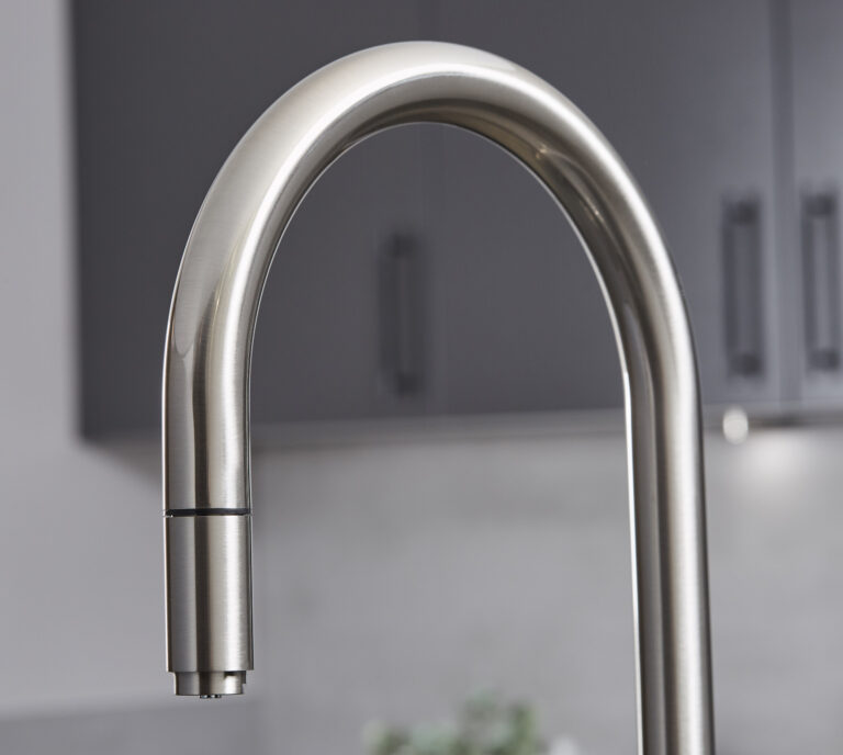 Close-up of a brushed nickel swan neck hot water tap