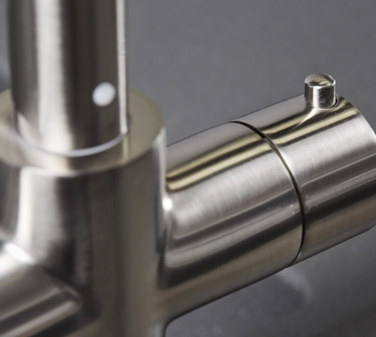 Close-up of a brushed nickel hot tap handle