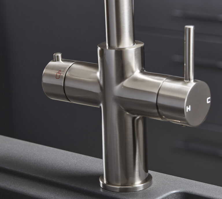 Close-up of a brushed nickel hot tap handle