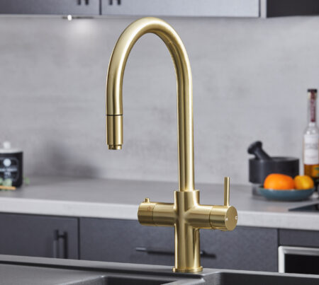 a swan neck pull-out hot water tap in gold