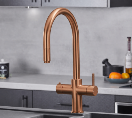 copper bronze boiling water tap in a modern kitchen